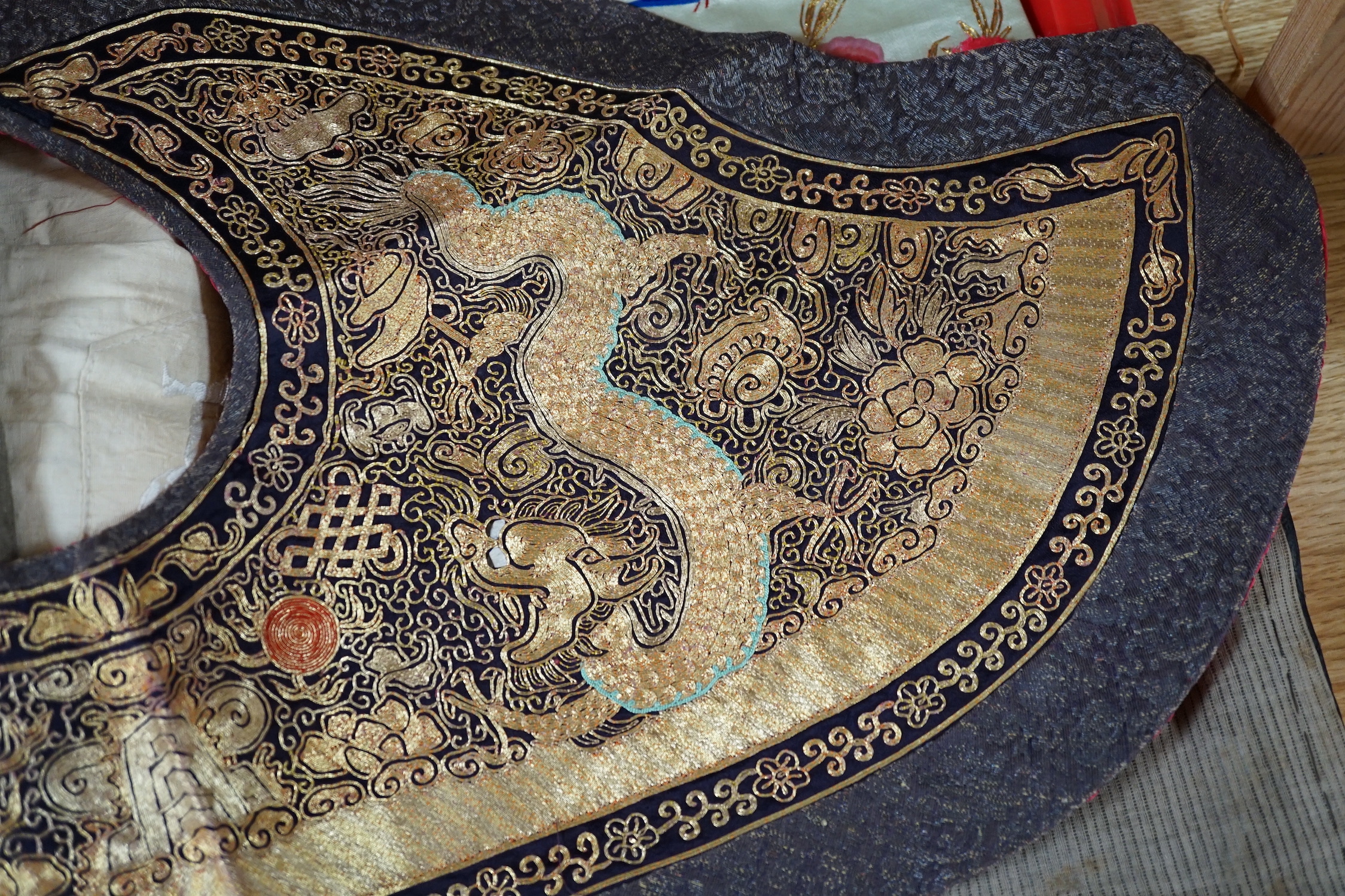 Two mid 20th century Chinese embroidered Rank Badges, a large gold thread dragon embroidered collar, three Chinese embroidered panels and a Japanese 1930’s Shantung silk dragon embroidered Kimono dressing gown